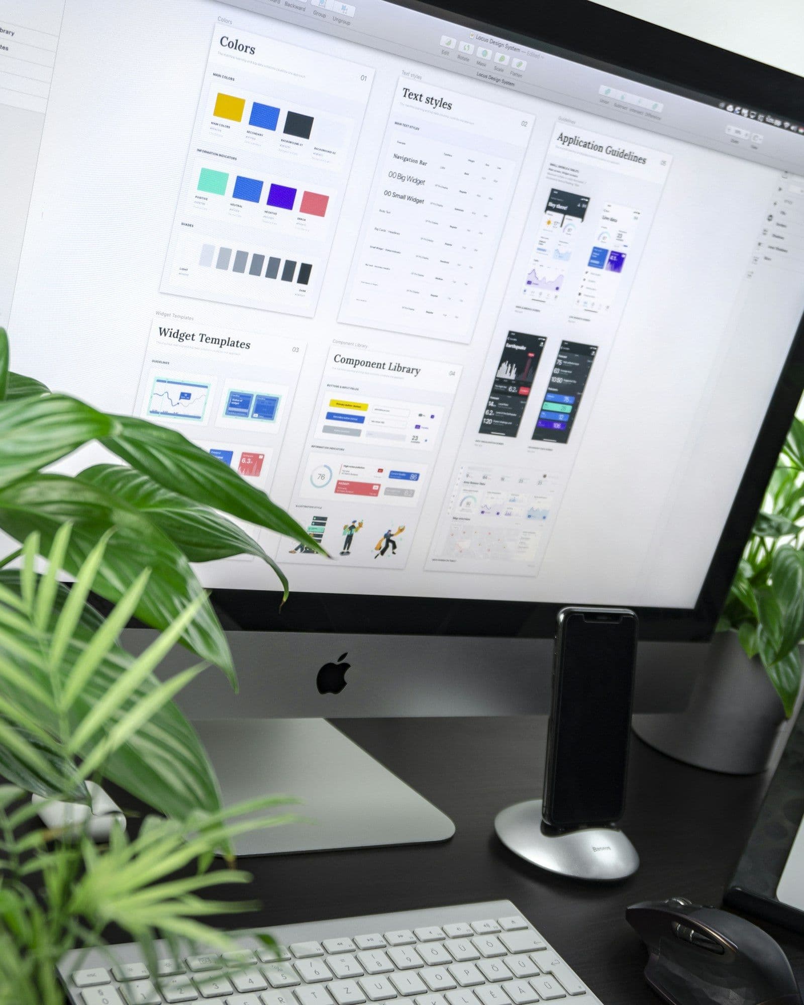 A monitor showing a design system: colour tokens, buttons and type styles