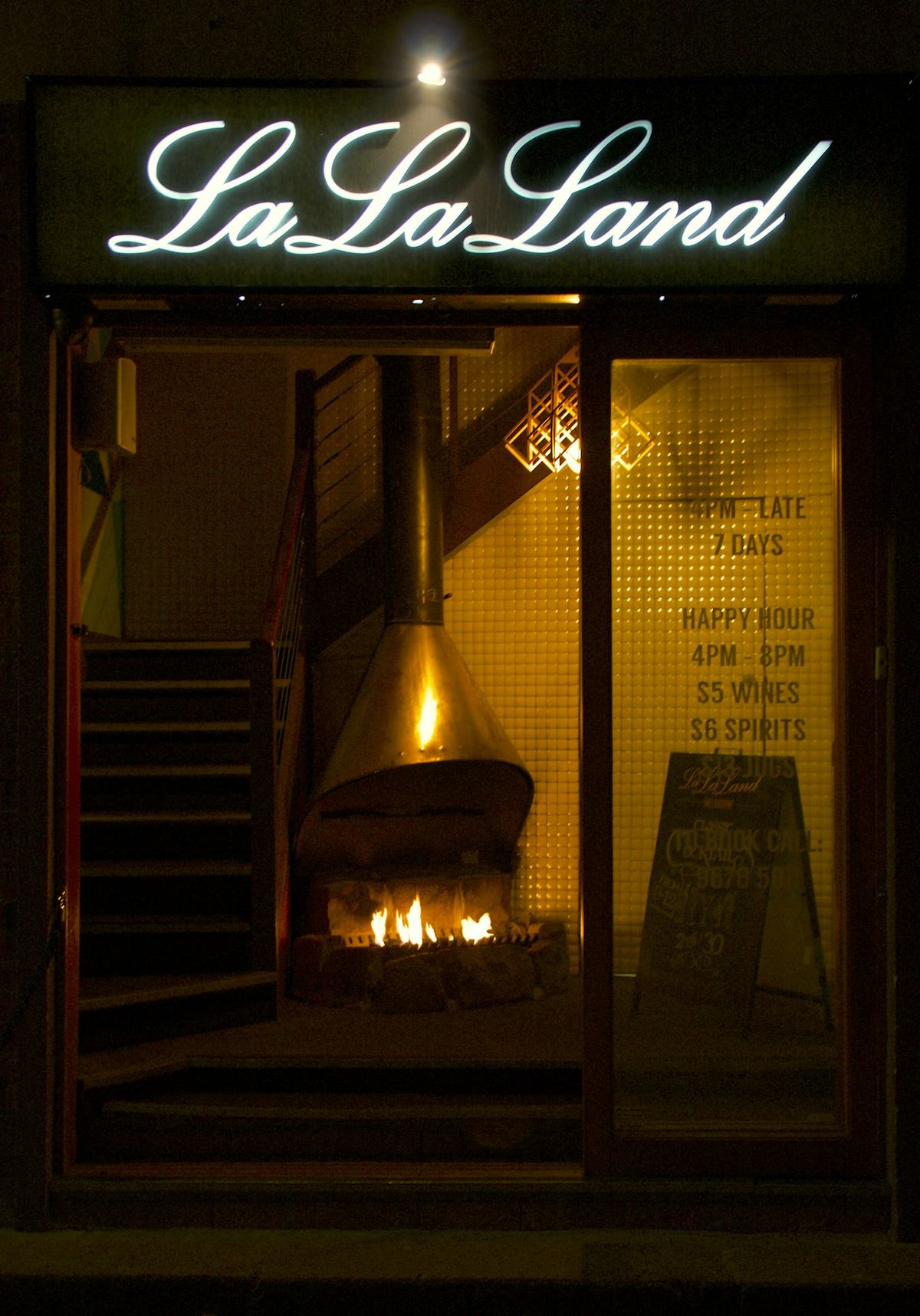 A fireplace burning in a warm corner